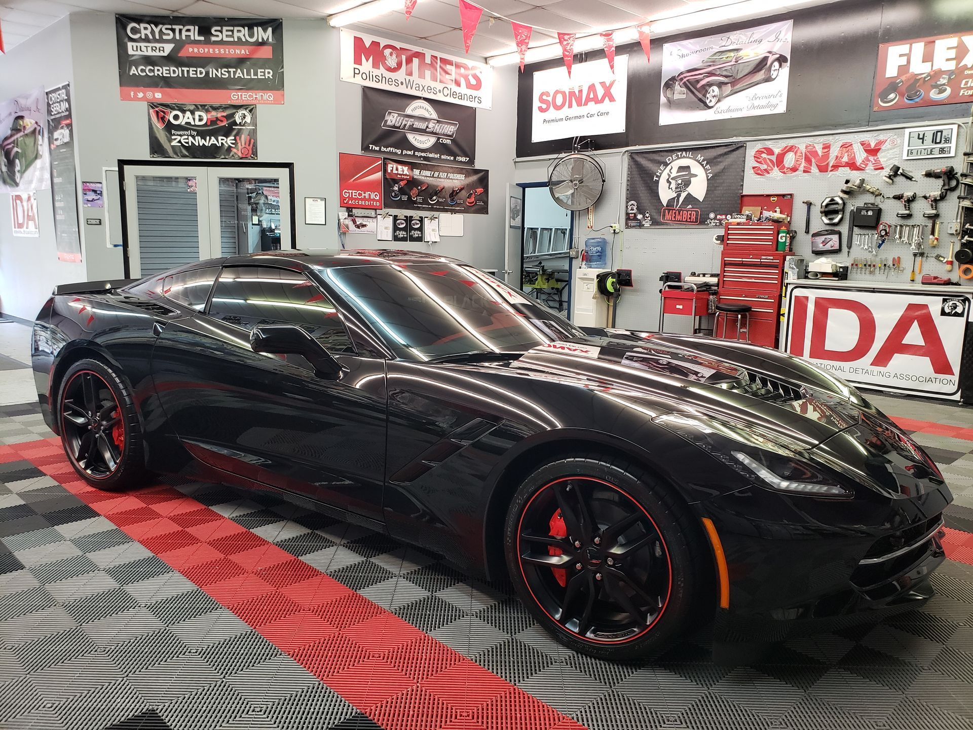 a black sports car is parked in a garage .