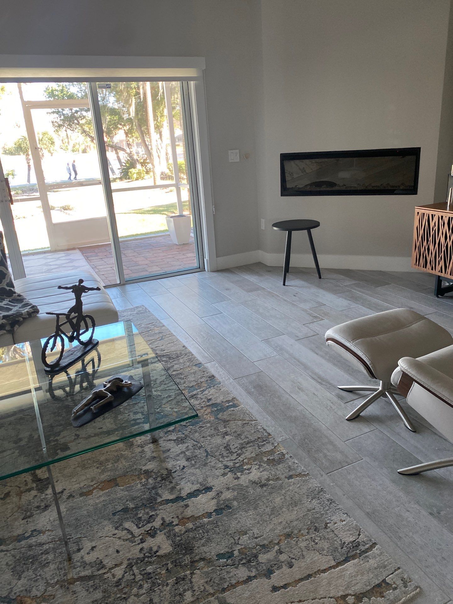 A living room with a sliding glass door and a fireplace.
