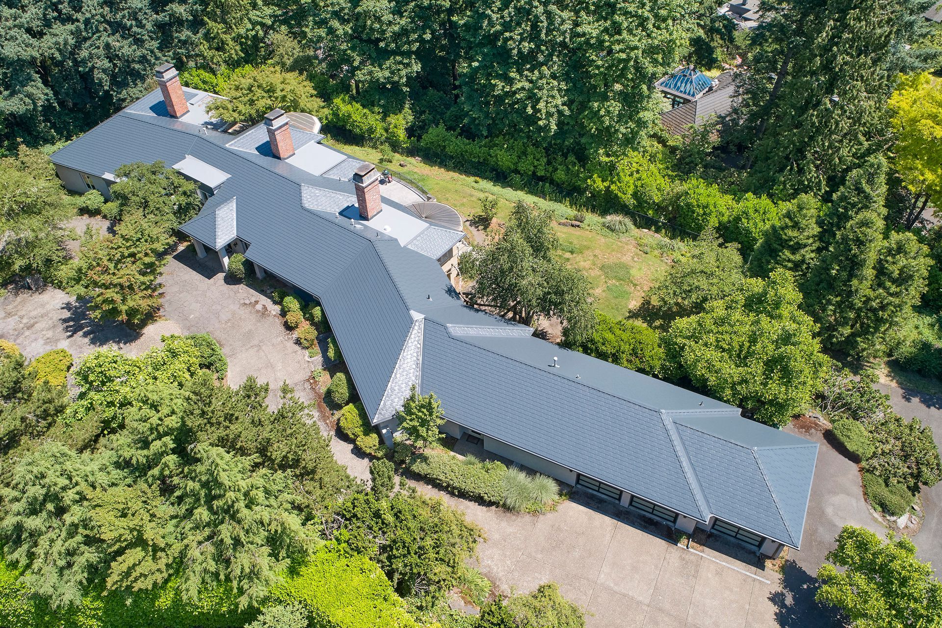 An aerial view of a house in Portland, Oregon with a Deep Charcoal Interlock Slate Roof.