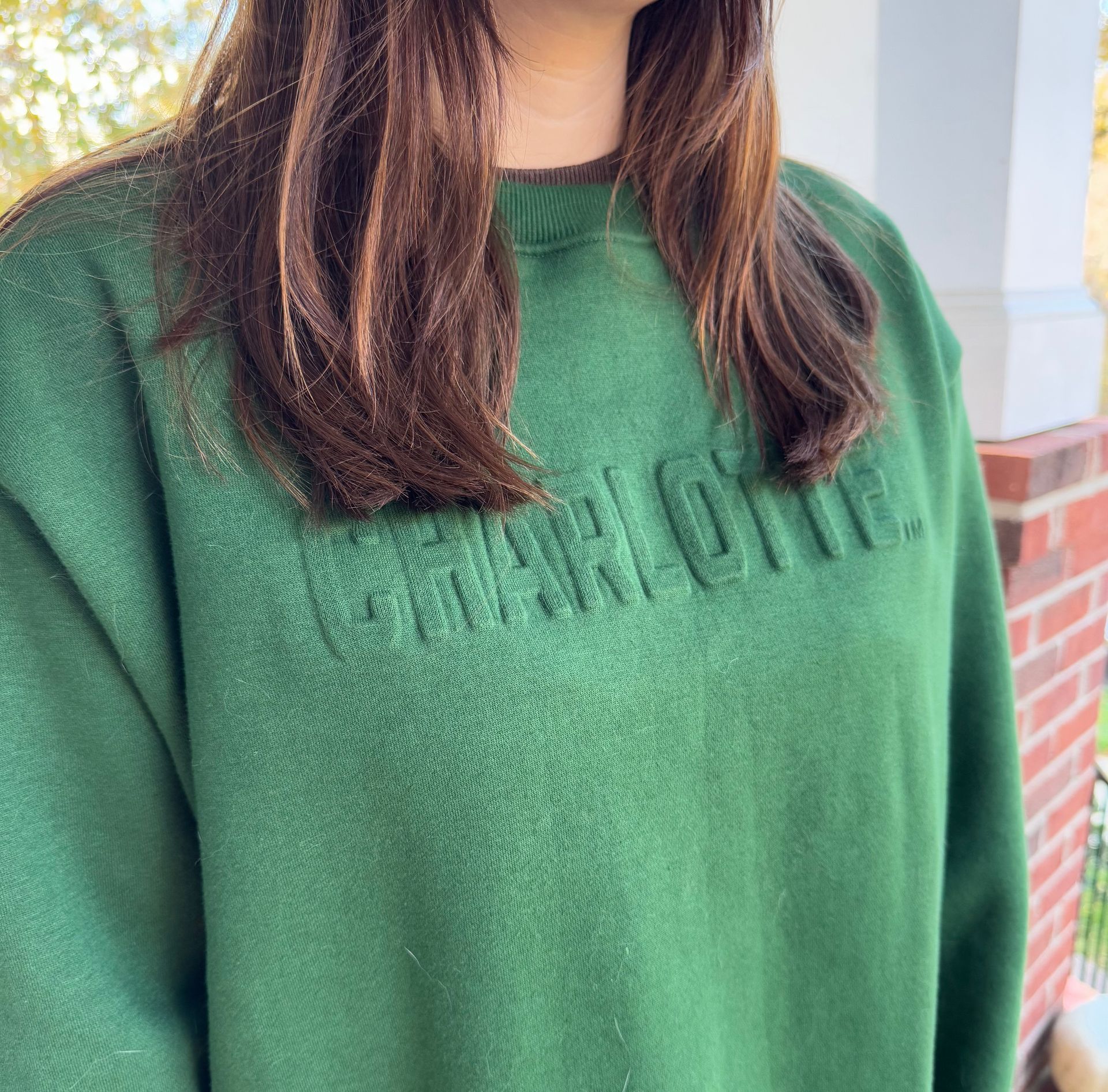 Woman in green sweatshirt with 