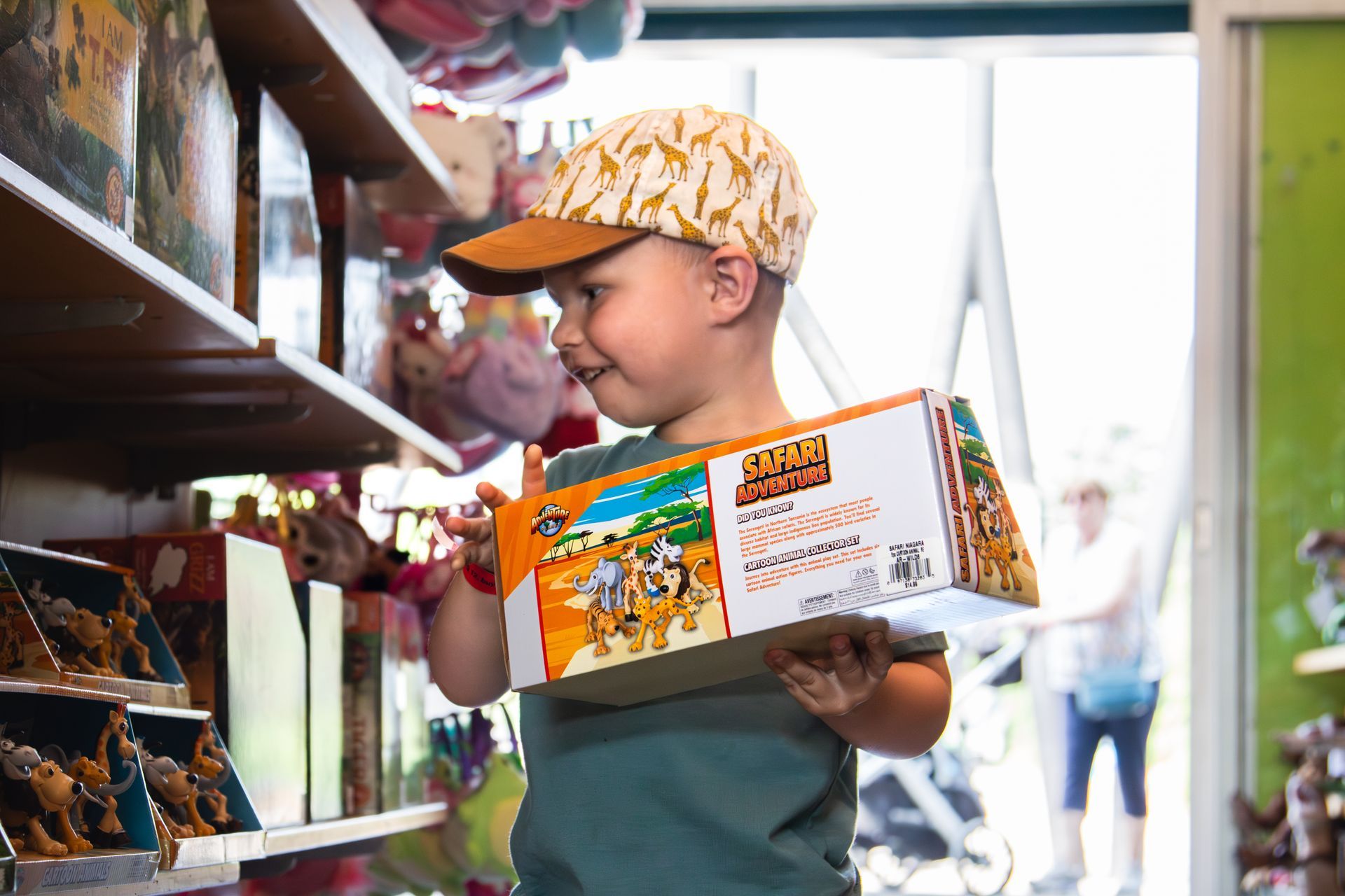 little kid grabbing a toy in the gift shop of safari niagara ontario
