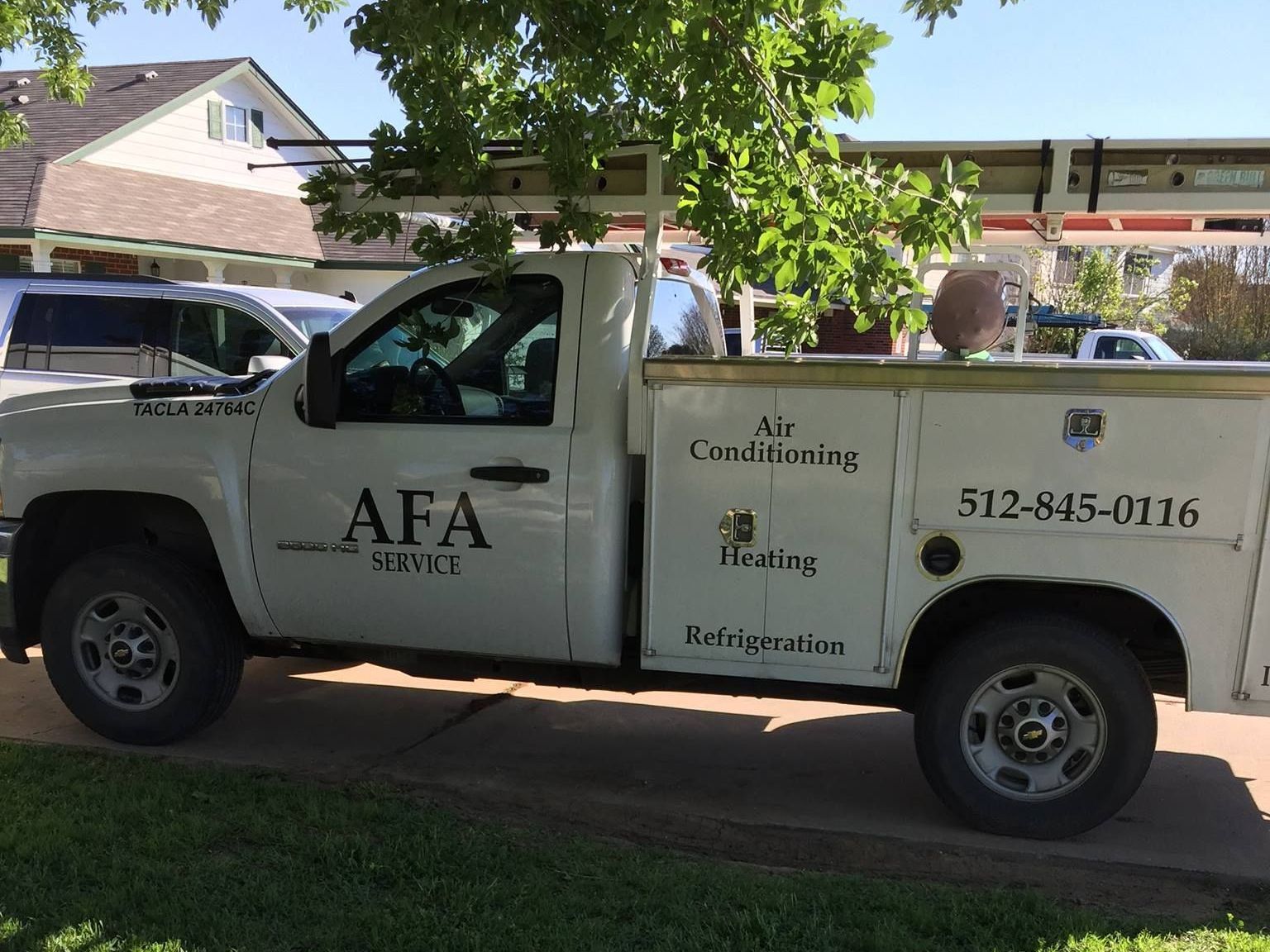 A white truck with the word afa on the side is parked in front of a house from AFA Service
