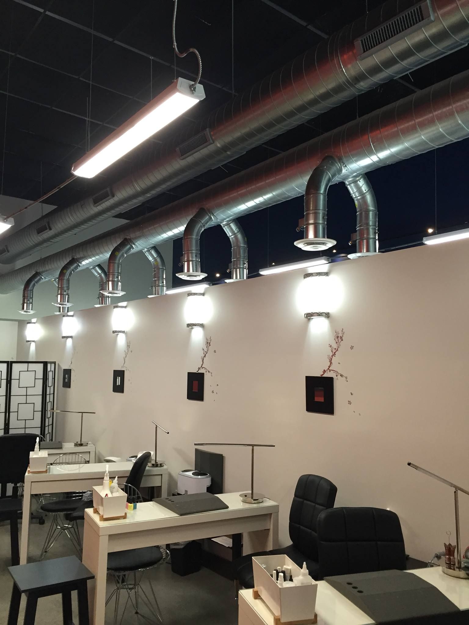 A room with a lot of tables and chairs in it with HVAC ductwork installed by AFA Service