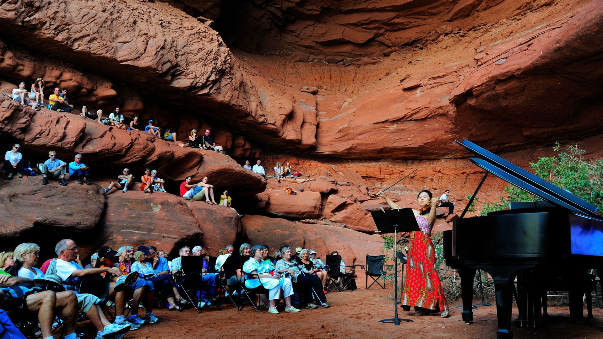 A violinist playing in the red rocks at the Moab Music Festival