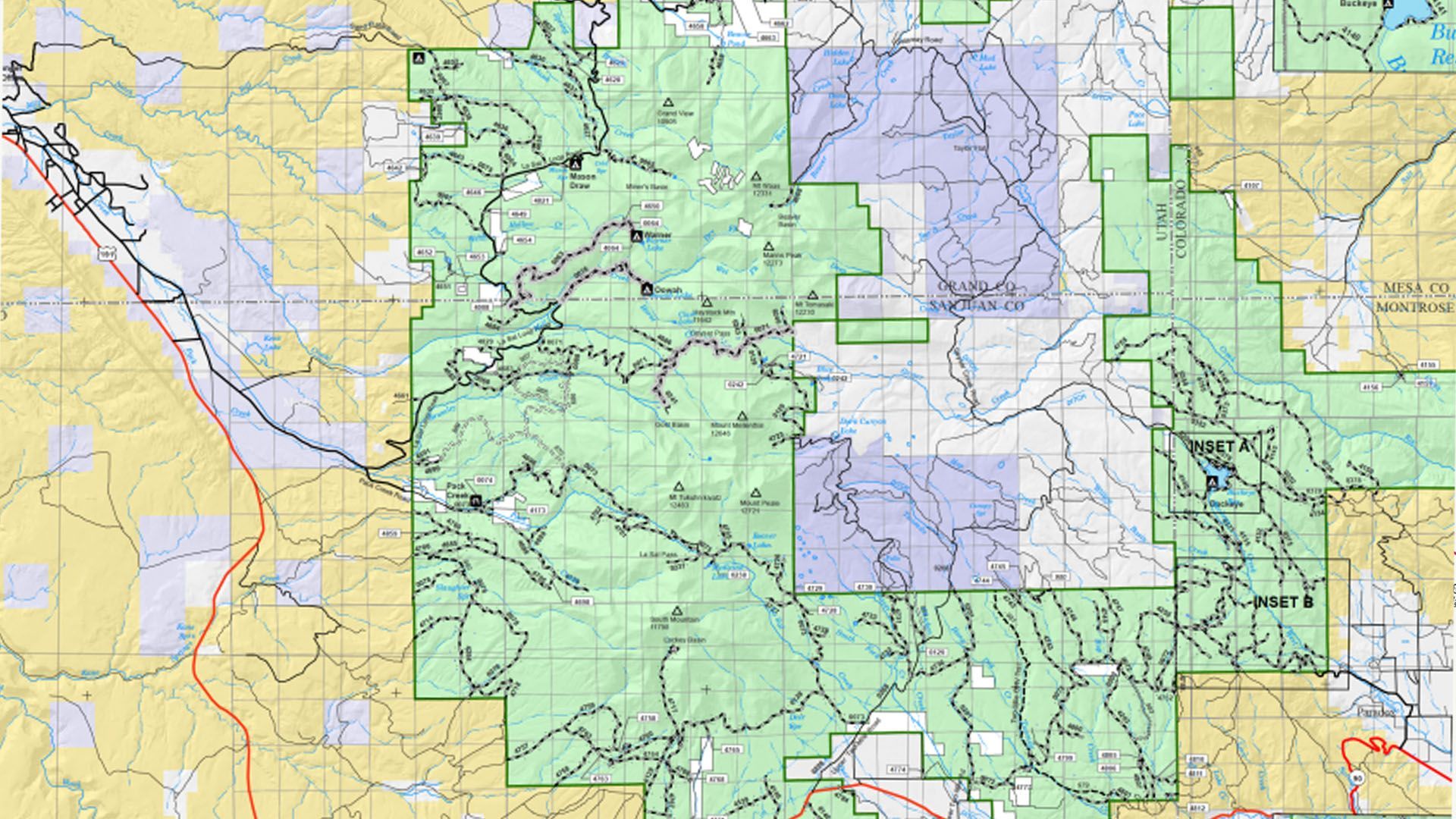 A topographic map with green and tan areas, showing trails, bodies of water, and elevation contours.