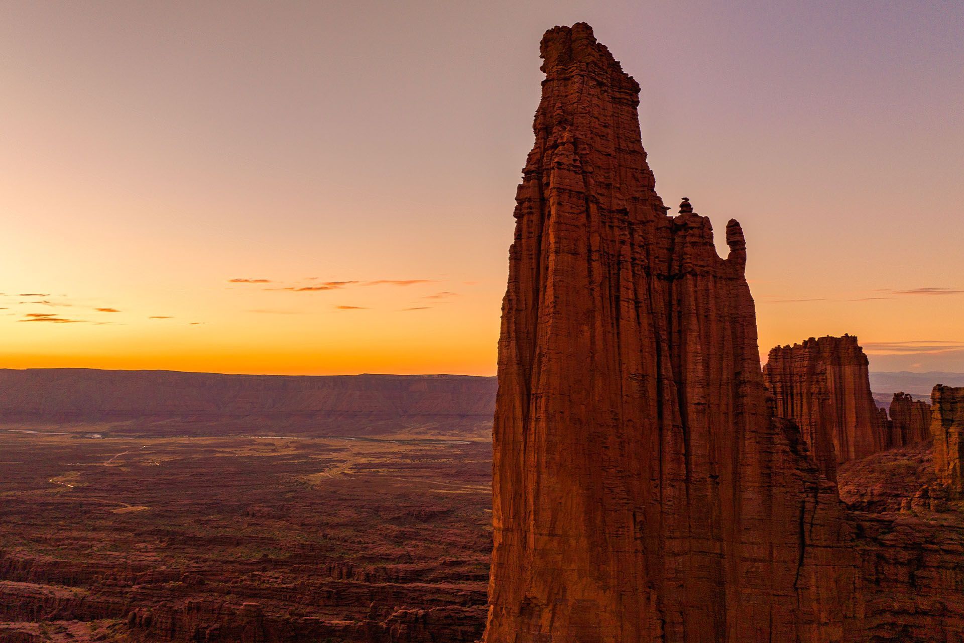 Fisher Towers dominate the foreground on a sunset glow over Castle Valley near Moab.