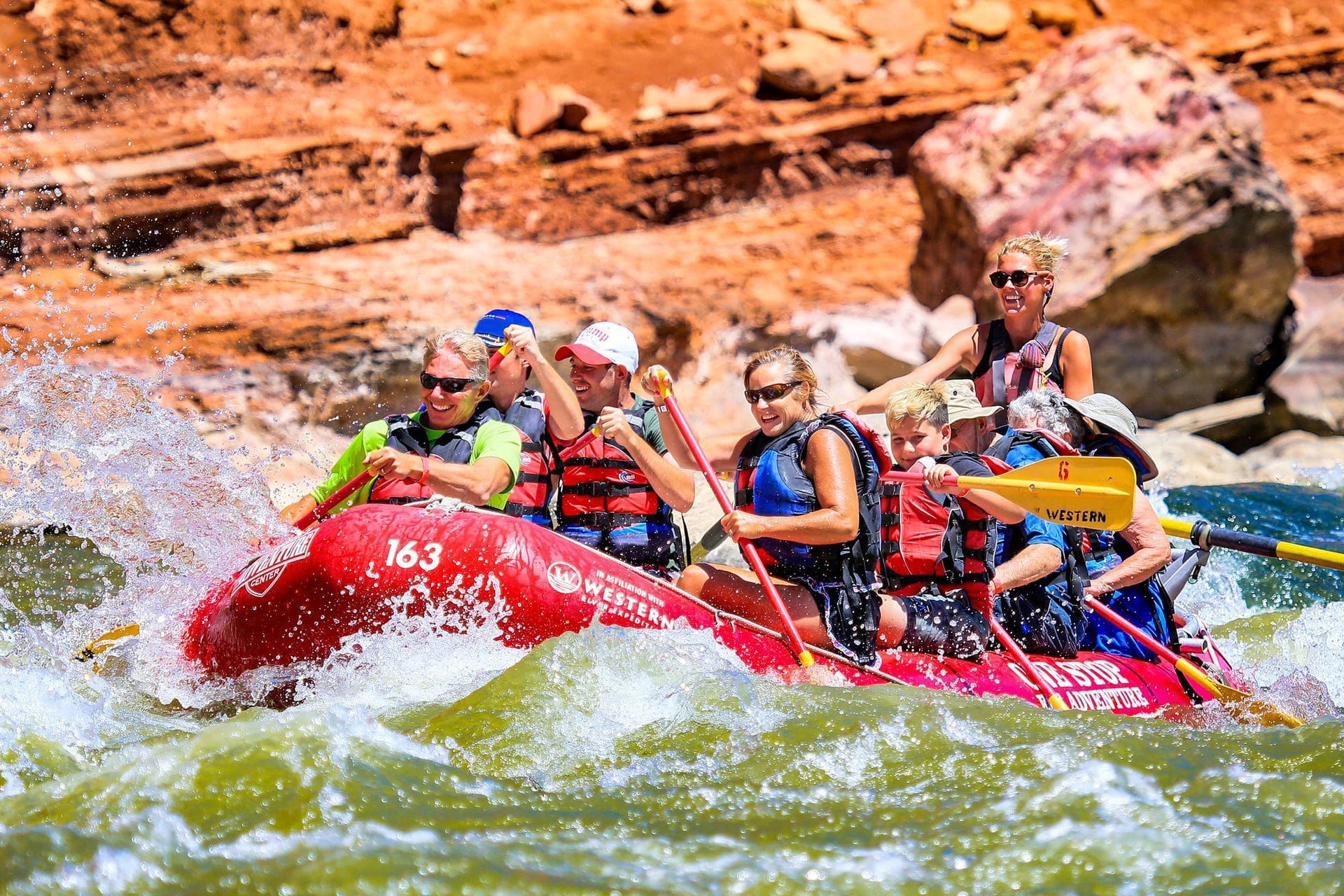A group with with Moab Adventure Center therafting the Colorado River on a red raft