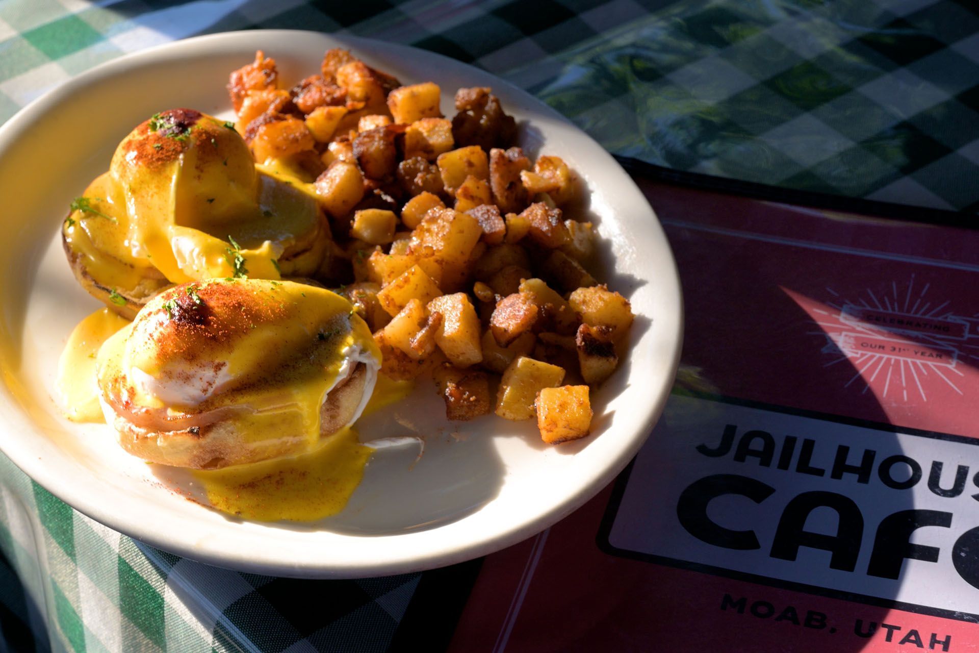 Eggs Benedict with fried potatoes on a plate at the Jailhouse Cafe in Moab, Utah.