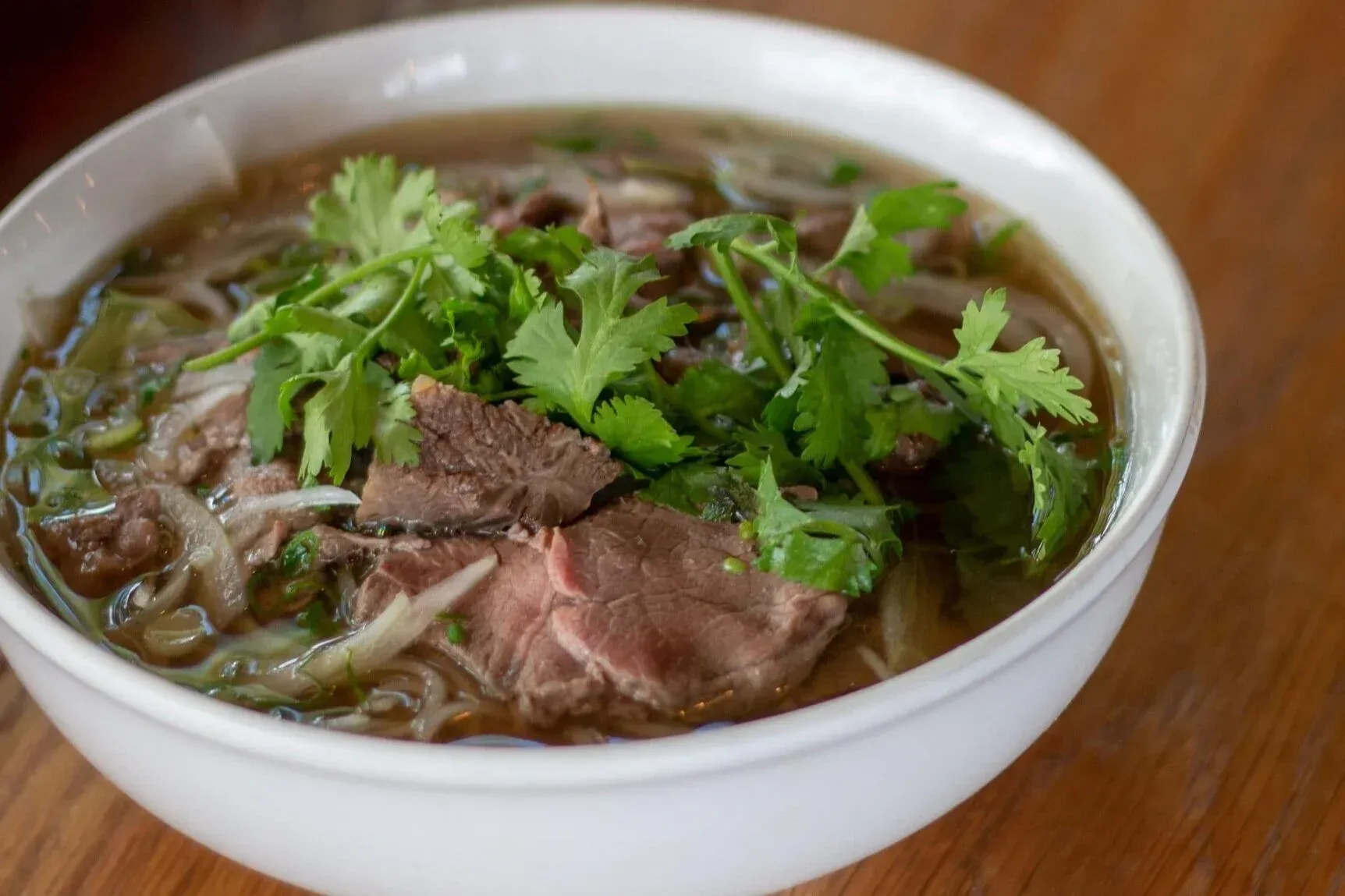 Beef Pho bowl with parsley on top.