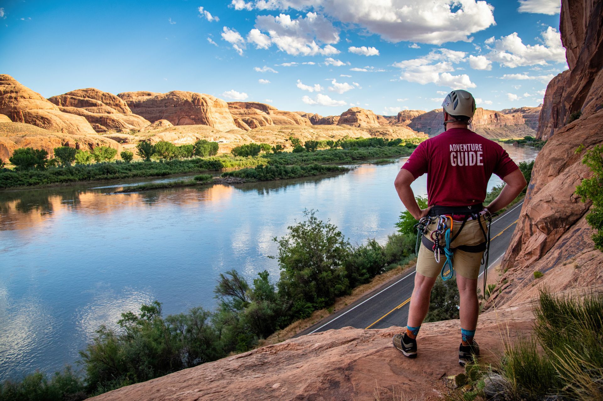 A rock climbing guide looks out from the top of a climb at the Colorado River along Wall Street at Potash Road.