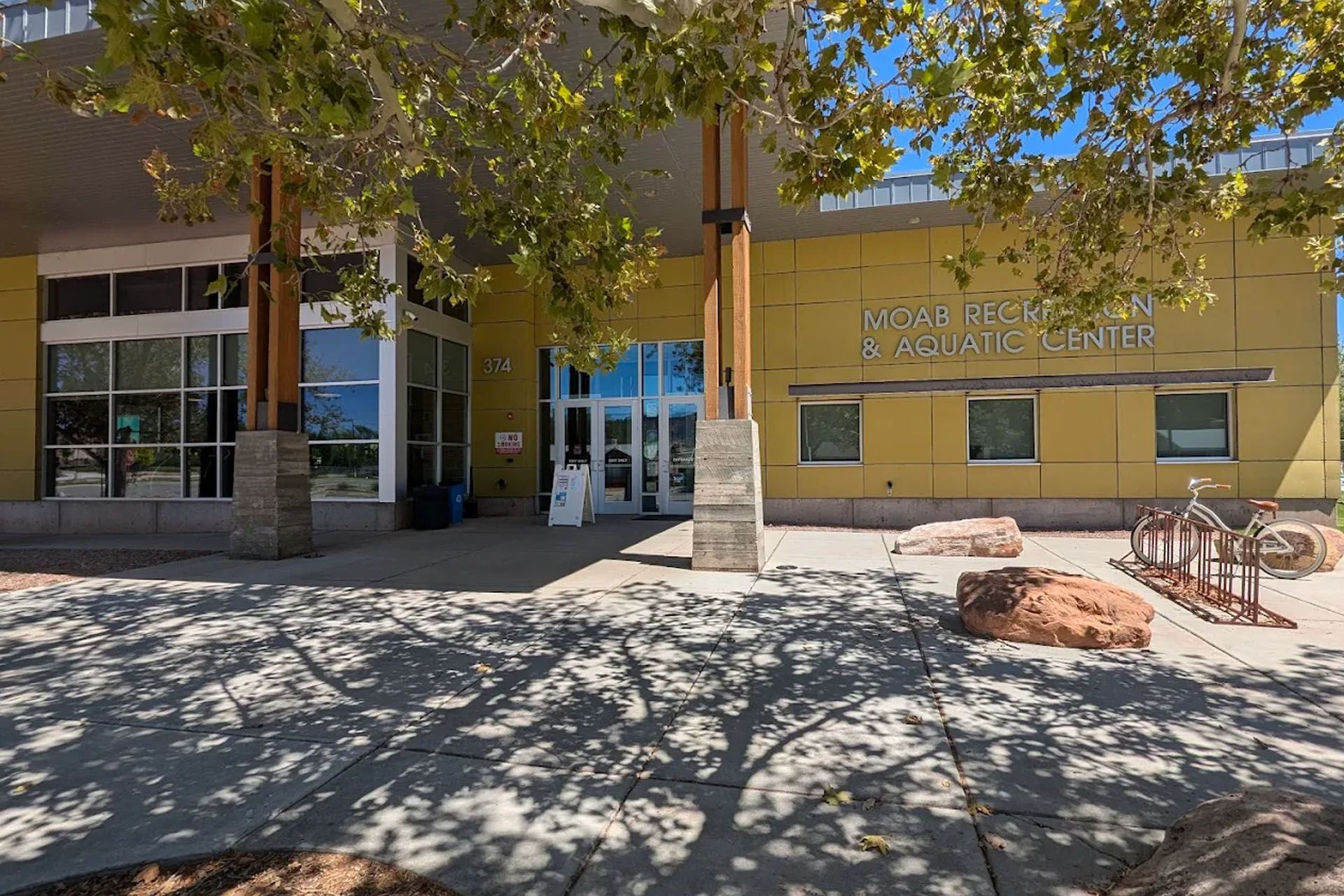 Front entrance of the Moab Recreation and Aquatic Center with trees.