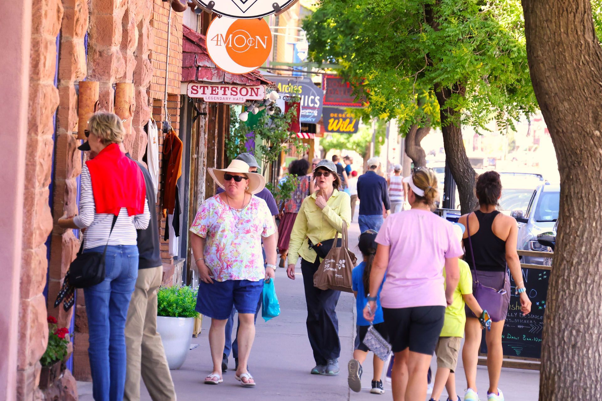 Tourists walking on Main Street past shops in downtown Moab