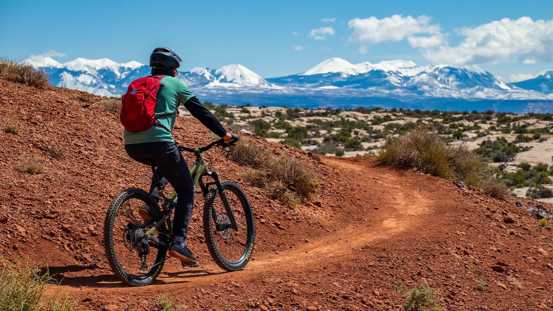 A man mountain biking on a beginner friendly trail in Moab, Utah.