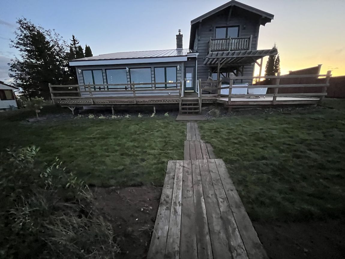 A house with a large deck and stairs leading to it