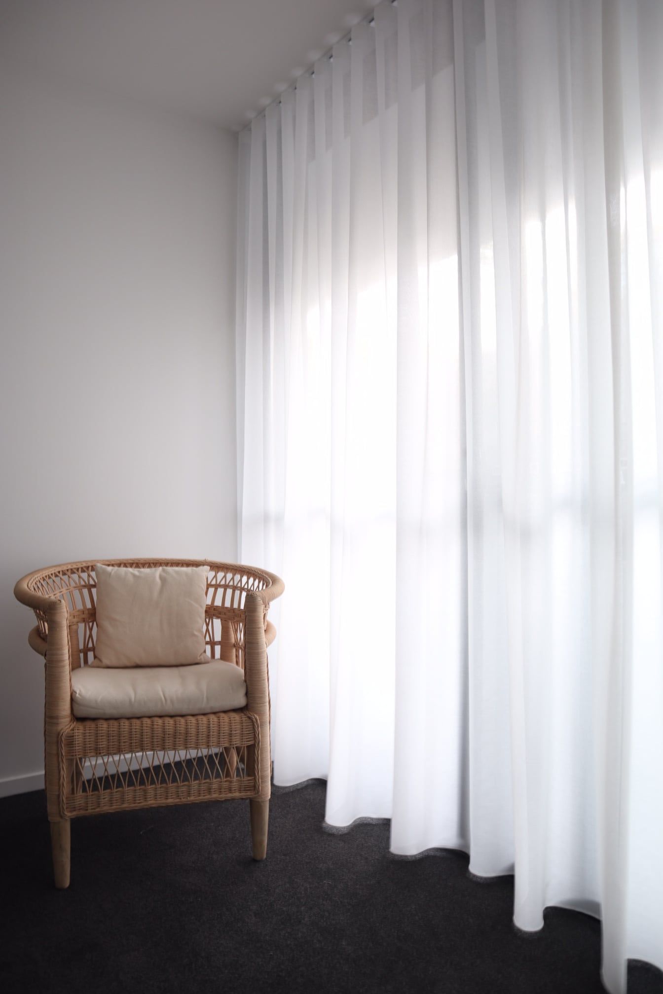 White Curtain And A Rattan Chair — Studio Curtains & Blinds in Mount Gravatt, QLD