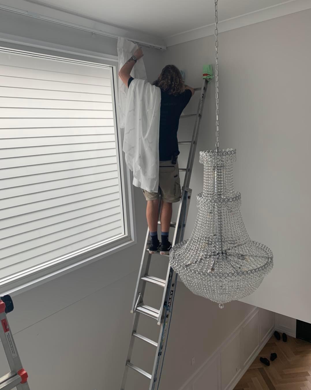 Man Installing A Curtains — Studio Curtains & Blinds in Brisbane, QLD