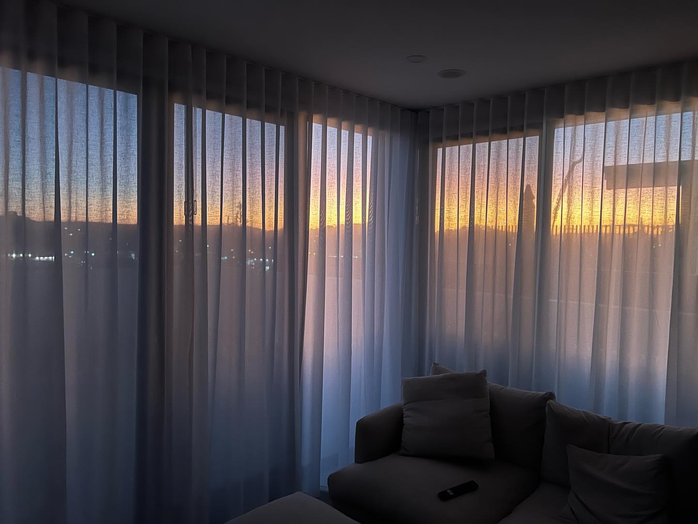 Sheer Curtains With A Sunset On A Background — Studio Curtains & Blinds in Mount Gravatt, QLD
