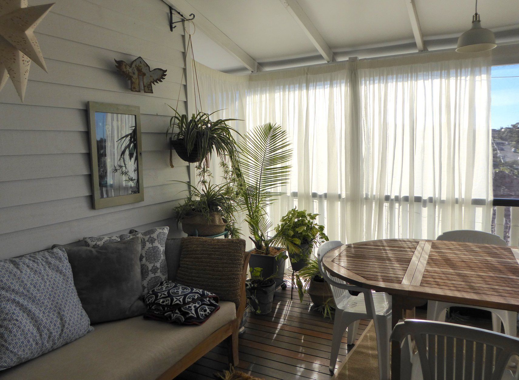 Cozy Living Room With White Pencil Pleated Curtains — Studio Curtains & Blinds in Mount Gravatt, QLD