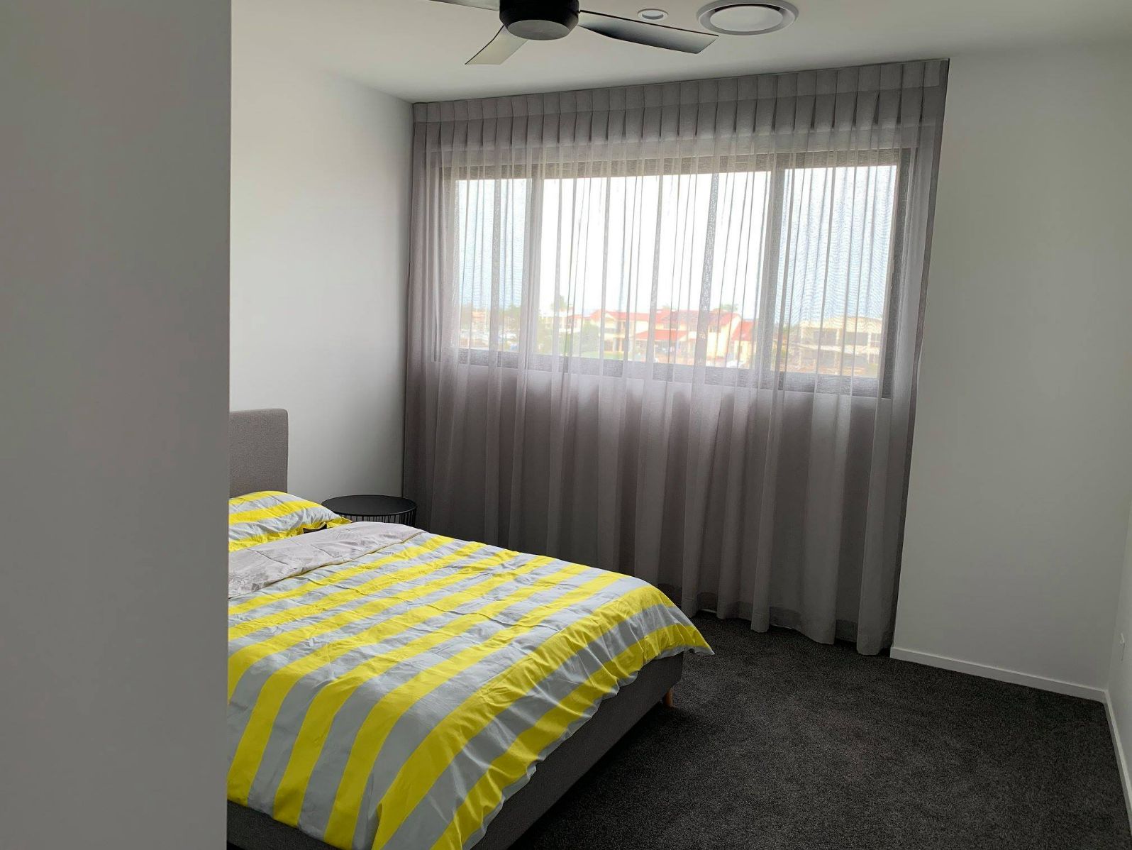 Bedroom With Yellow & Grey Stripes Bed & Curtains — Studio Curtains & Blinds in Mount Gravatt, QLD