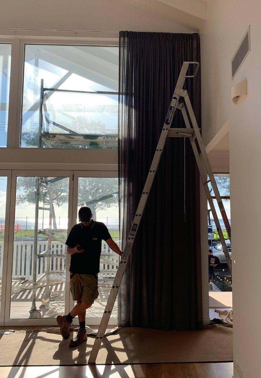 Man Standing Beside The Ladder — Studio Curtains & Blinds in Mount Gravatt, QLD