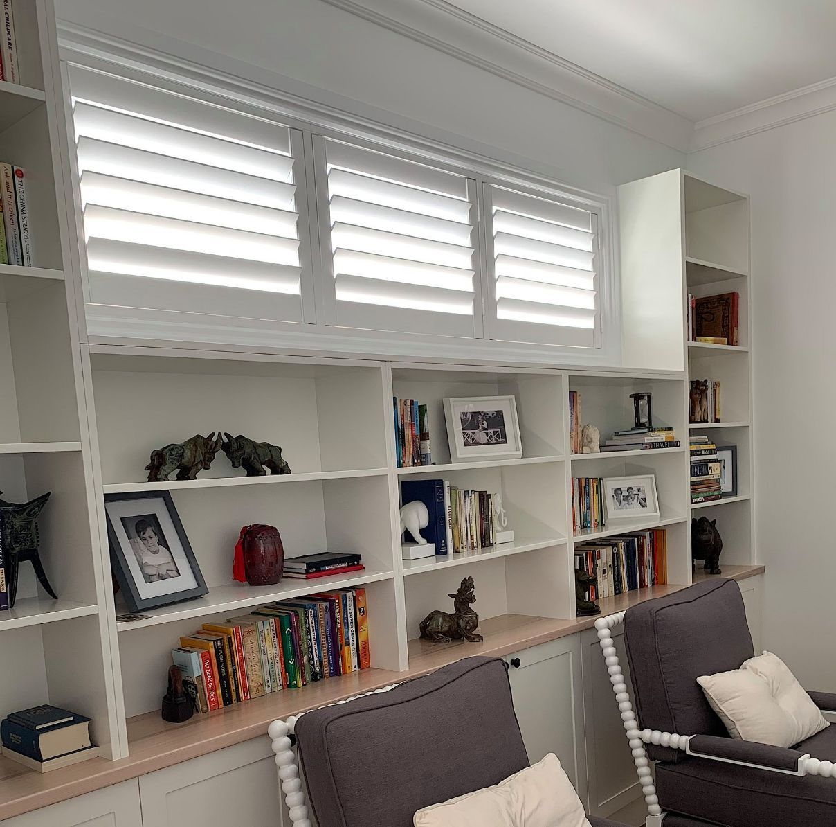 Window Shutters Above The Book Shelves — Studio Curtains & Blinds in Brisbane Southside, QLD