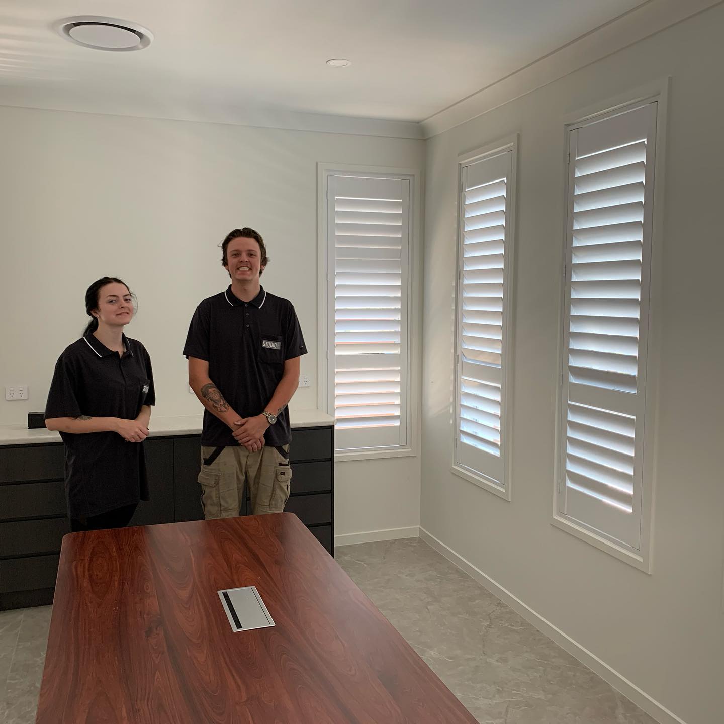 Happy Man & Woman After Installing Shutters — Studio Curtains & Blinds in Mount Gravatt, QLD