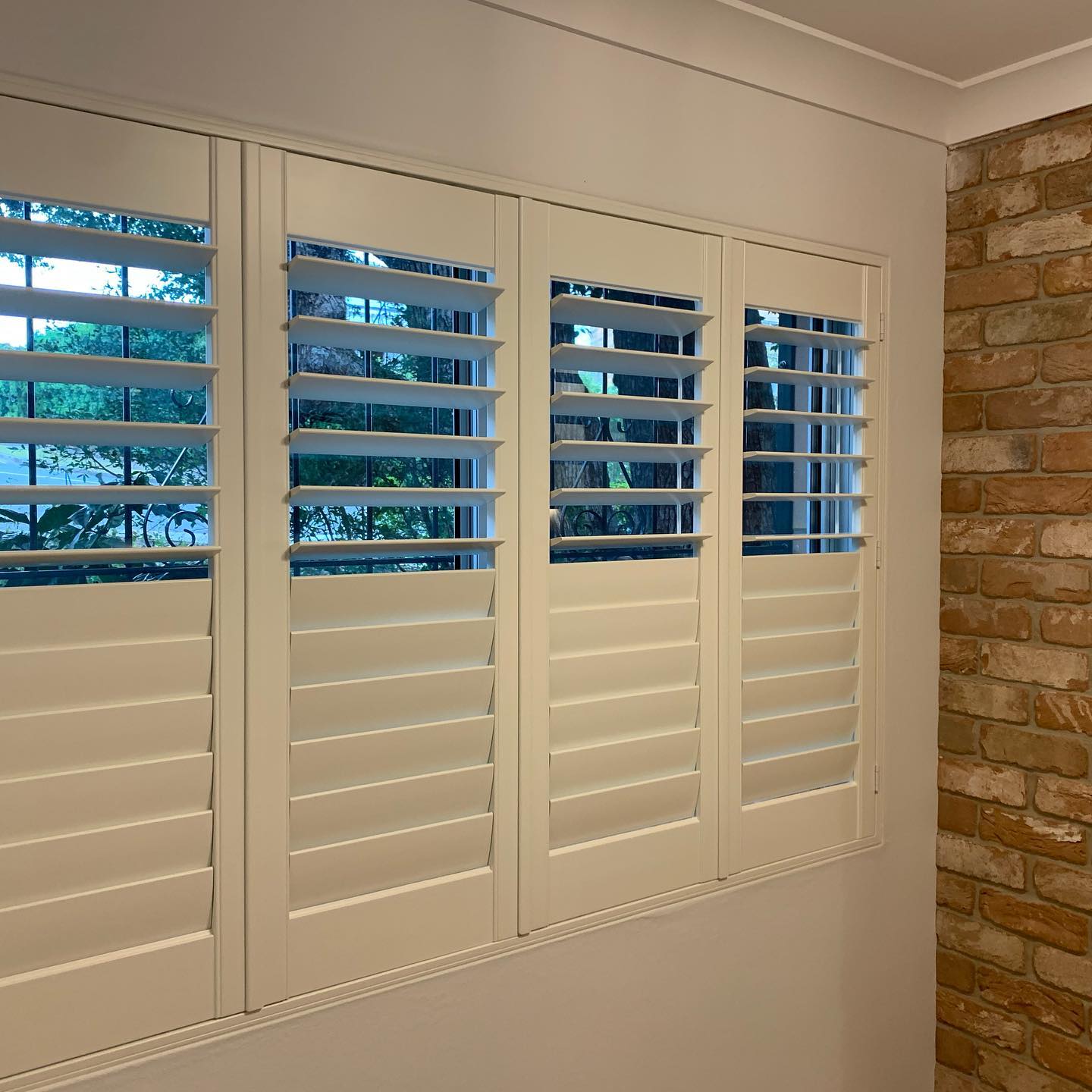 White Shutters Fitting Into Bricks — Studio Curtains & Blinds in Mount Gravatt, QLD