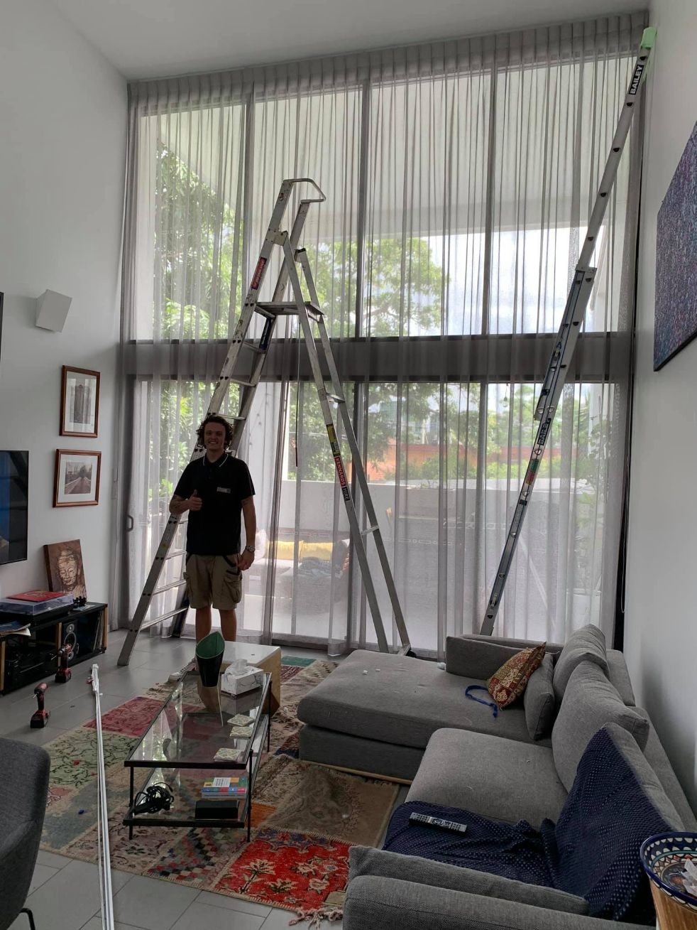 Man Installed An Inverted Pleat Curtains On A High Ceiling — Inverted Pleat Curtains in Brisbane, QLD