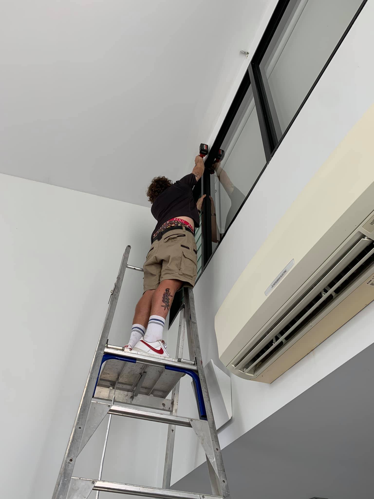 Man Installing A Curtains — Studio Curtains & Blinds in Mount Gravatt, QLD