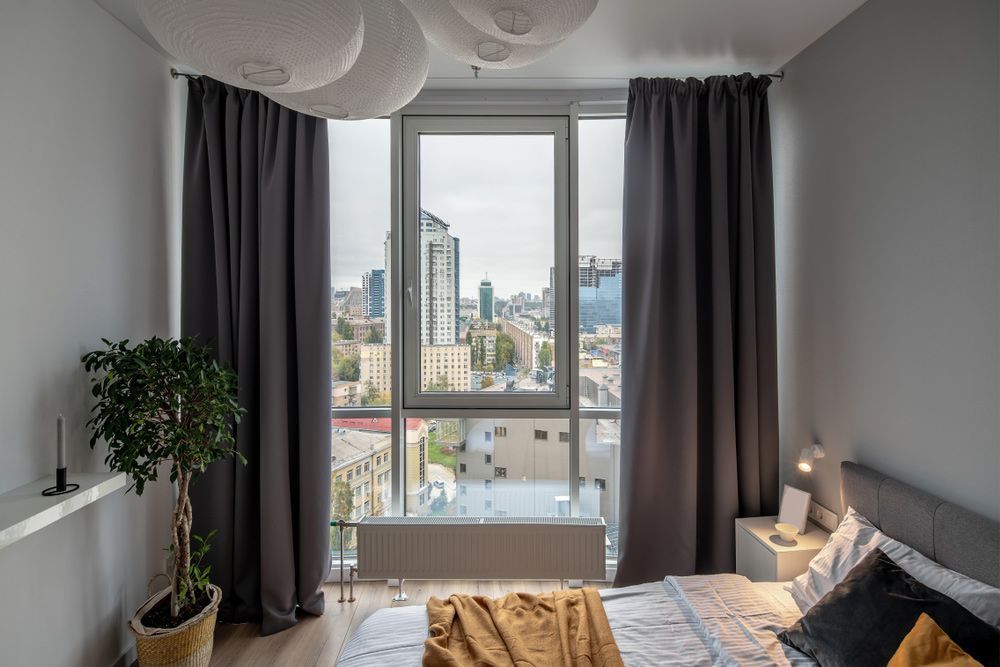 Bedroom With A Blockout Curtain — Studio Curtains & Blinds in Mount Gravatt, QLD