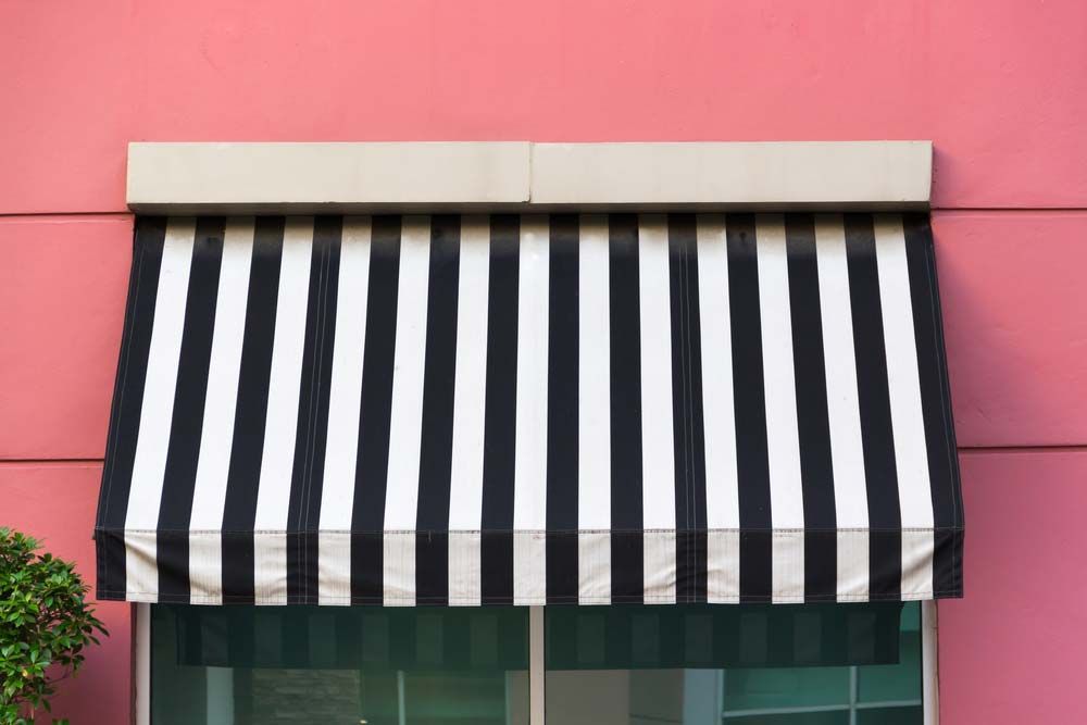 Black And White Awnings On Pink Wall — Studio Curtains & Blinds in Mount Gravatt, QLD
