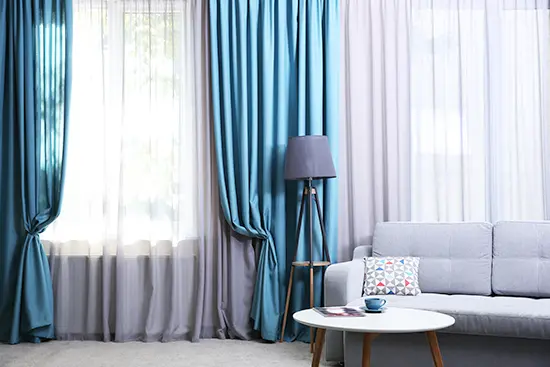 Living Room With Blue Curtains — Studio Curtains & Blinds in Mount Gravatt, QLD