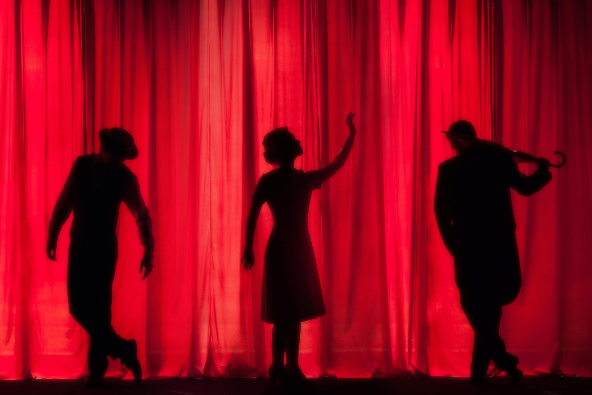 Silhouette Of Three Performers On Stage — Studio Curtains & Blinds in Mount Gravatt, QLD