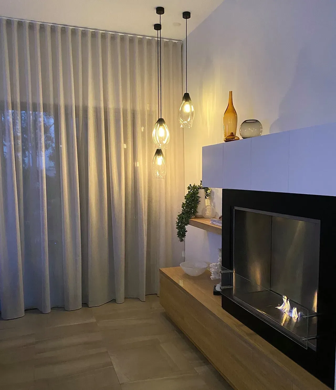 A Living Room With a Fireplace and Curtains Hanging From the Ceiling — Studio Curtains & Blinds in Mount Gravatt, QLD