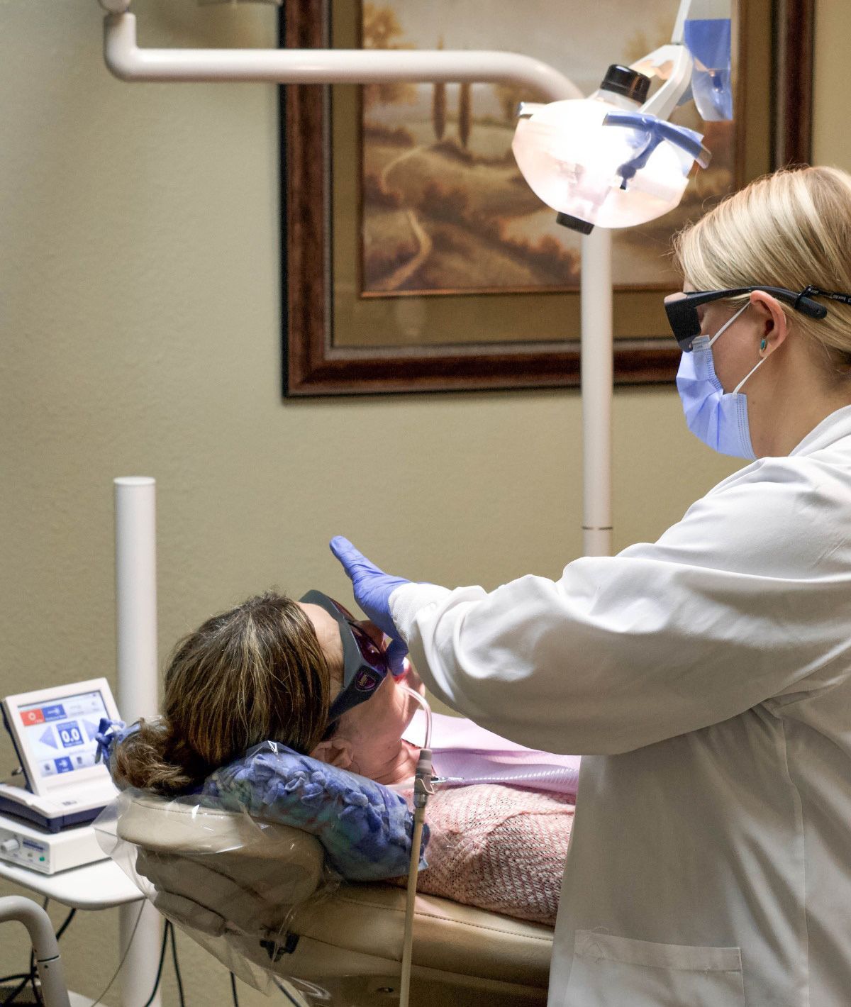 Dentist examining a patient's mouth. Dentist examining a patient's mouth.