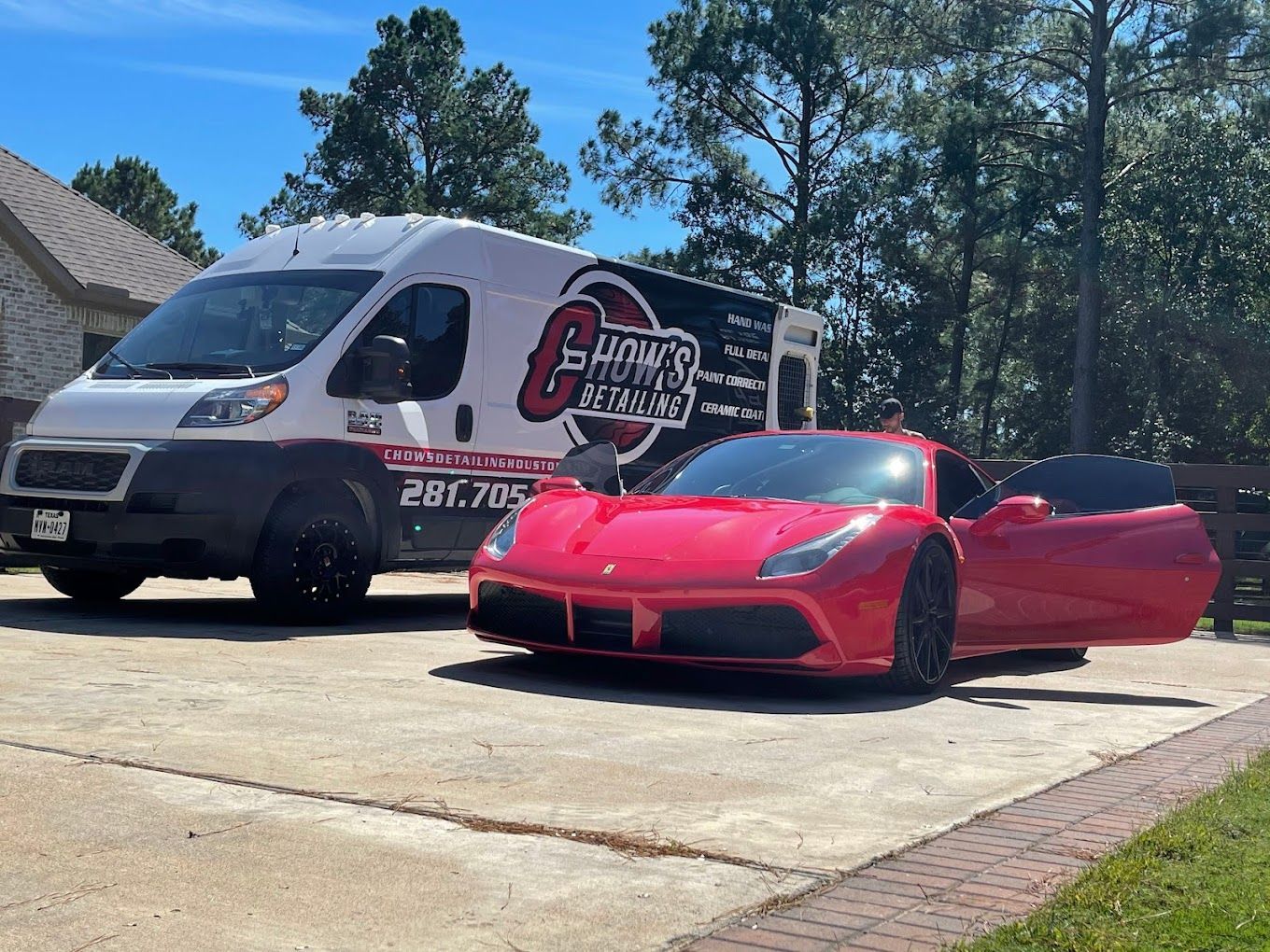 ceramic coated red car with open doors beside Chow's Detailing mobile van