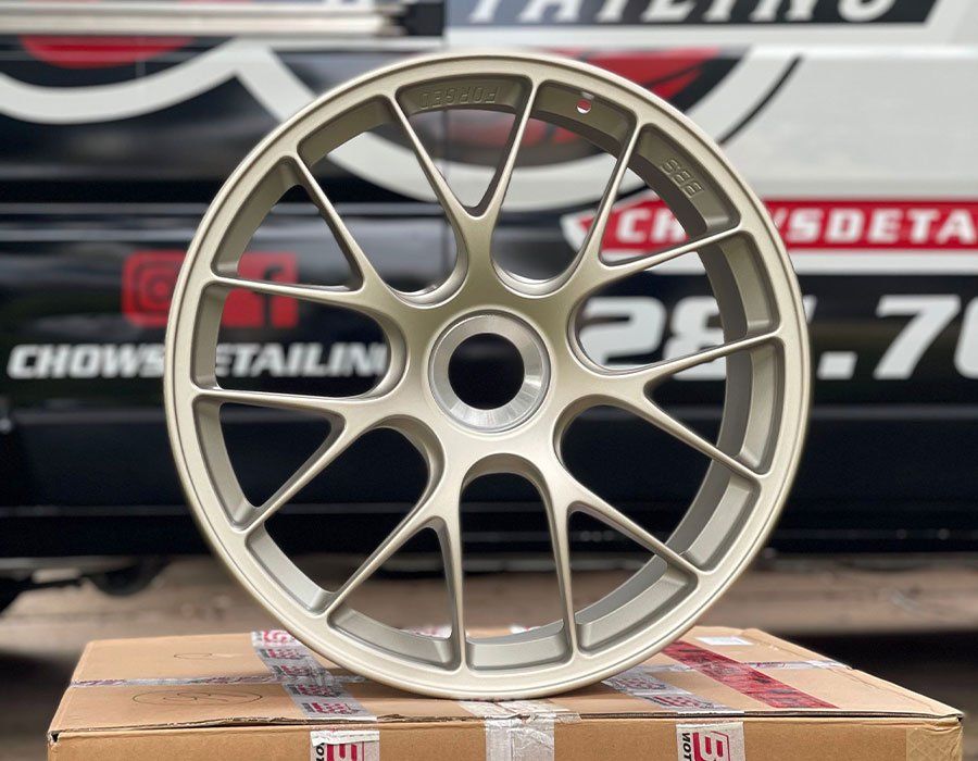 a close up of a wheel on a box in front of a van