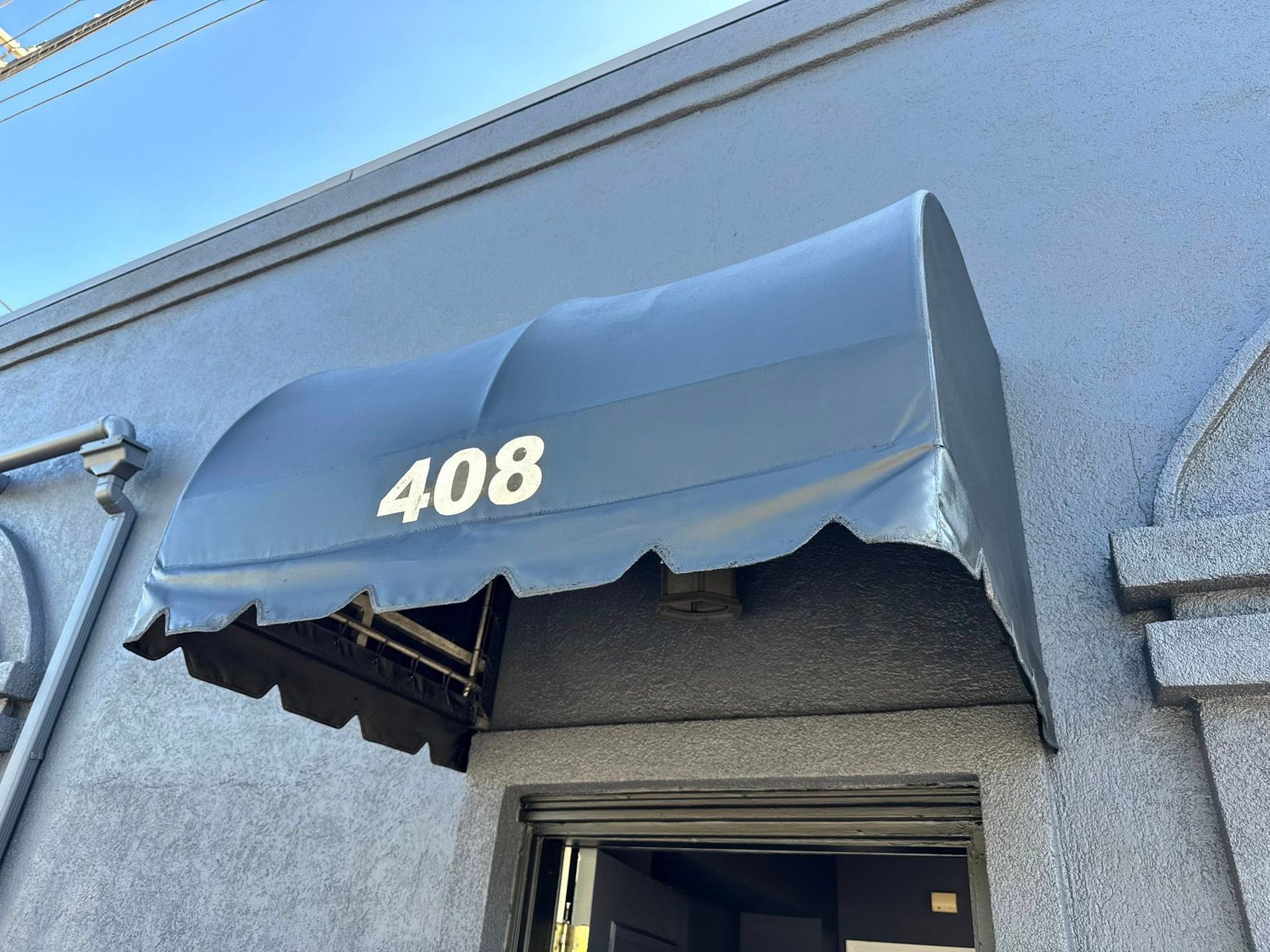 Blue awning over door with white 