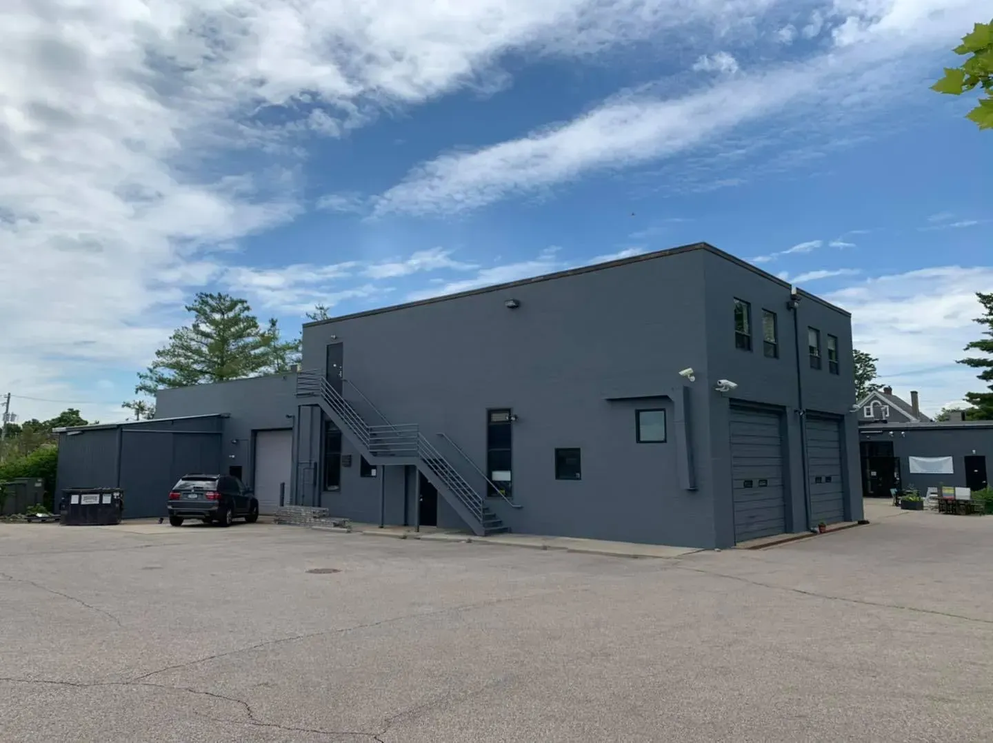 A large gray building with stairs leading up to the top of it.