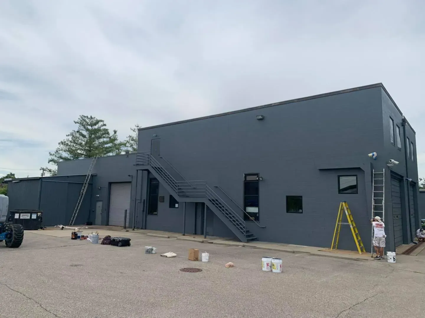 A man is painting the side of a building.