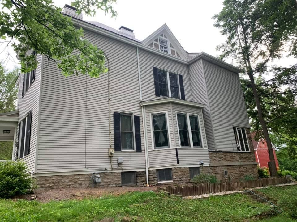 A large house with a lot of windows and siding