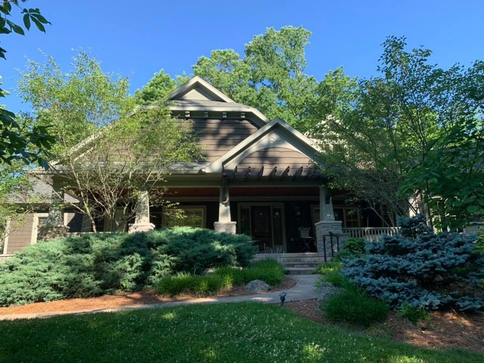 A house with a lot of trees in front of it