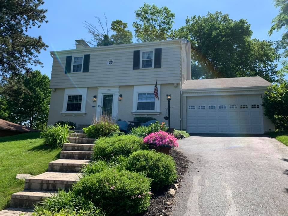 A house with a garage and stairs leading up to it