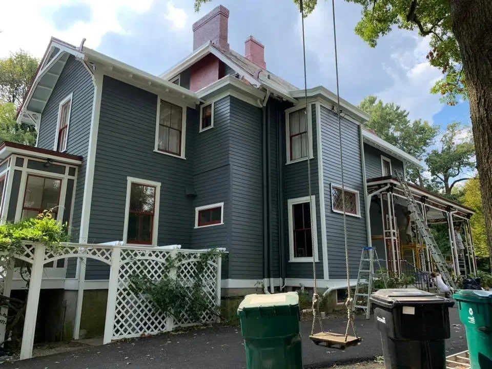 A large house with a swing in front of it