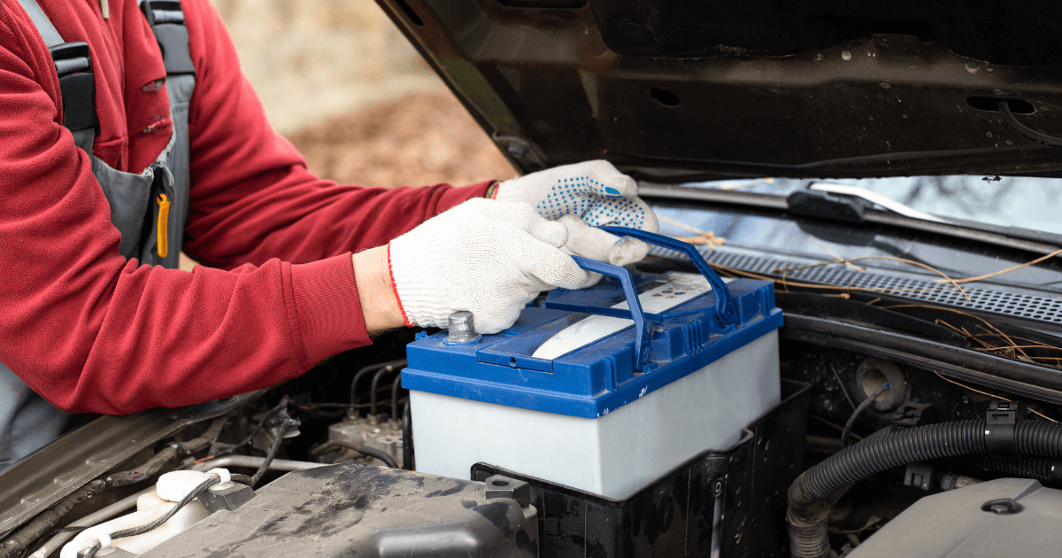 A mechanic doing a battery replacement.