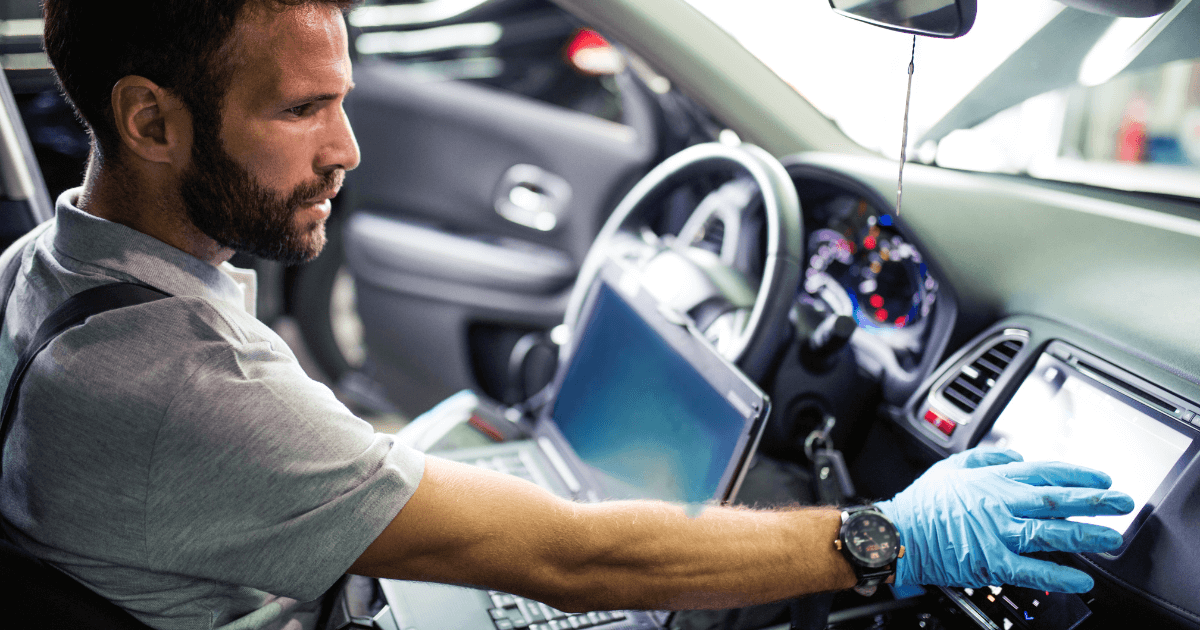 a mechanic doing an inspection inside a car