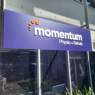 A purple sign for momentum physio + rehab