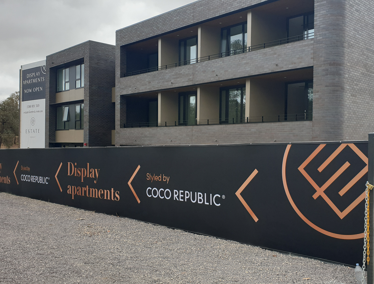 A building with a fence around it that says coco republic A building with a fence around it that says coco republic
