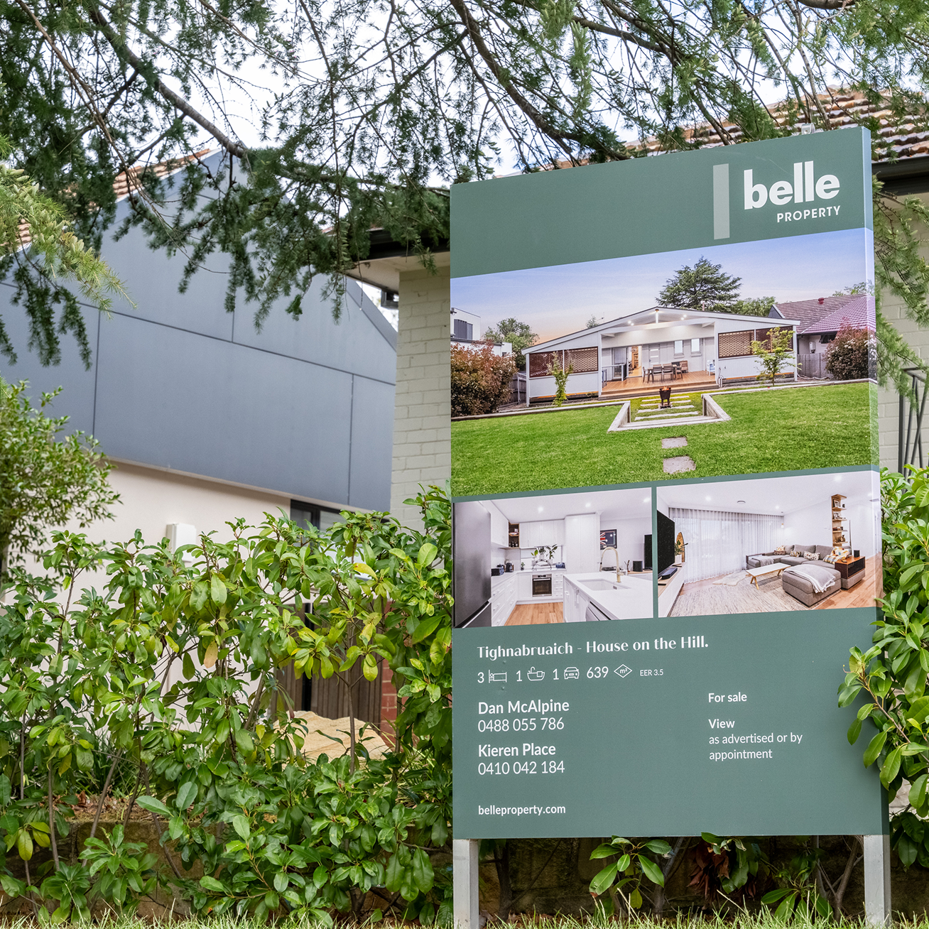 A house with a for sale sign in front of it