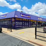 A purple building with a sign that says ' battery world ' on it